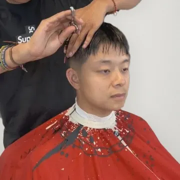 Scissor cut in progress at Precision Barber Co.