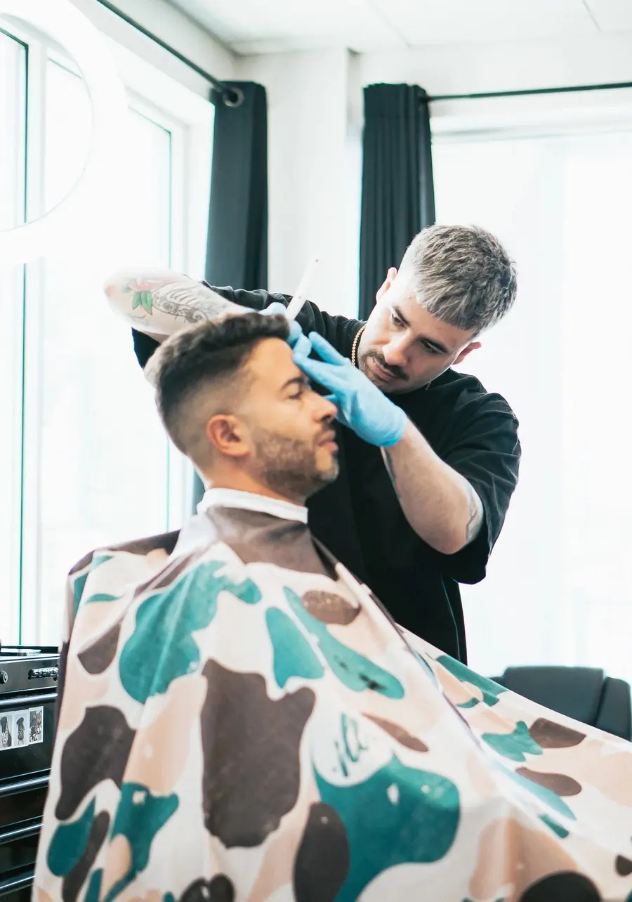 Barber at work at Precision Barber Co.